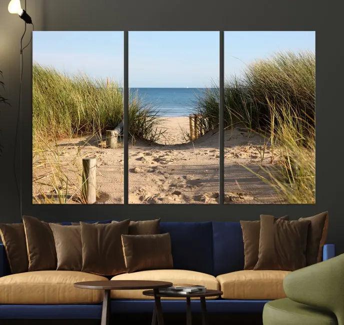 The Coastal Beach Print, showcasing a pathway to beach dunes with grass, is elegantly displayed on a gallery-wrapped museum-quality canvas. This ocean wall art canvas print features a UV-protective coating for enduring beauty.