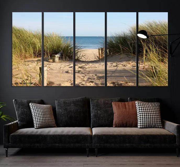 The Coastal Beach Print, showcasing a pathway to beach dunes with grass, is elegantly displayed on a gallery-wrapped museum-quality canvas. This ocean wall art canvas print features a UV-protective coating for enduring beauty.