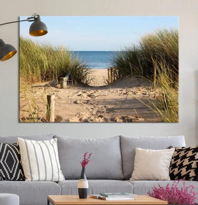 The Coastal Beach Print, showcasing a pathway to beach dunes with grass, is elegantly displayed on a gallery-wrapped museum-quality canvas. This ocean wall art canvas print features a UV-protective coating for enduring beauty.