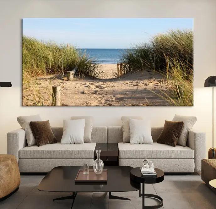 The Coastal Beach Print, showcasing a pathway to beach dunes with grass, is elegantly displayed on a gallery-wrapped museum-quality canvas. This ocean wall art canvas print features a UV-protective coating for enduring beauty.