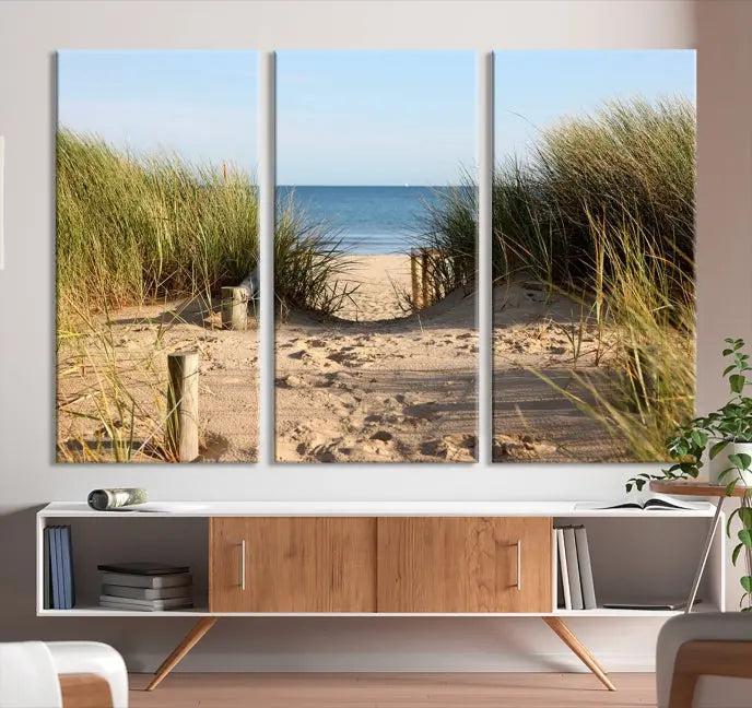 The Coastal Beach Print, showcasing a pathway to beach dunes with grass, is elegantly displayed on a gallery-wrapped museum-quality canvas. This ocean wall art canvas print features a UV-protective coating for enduring beauty.