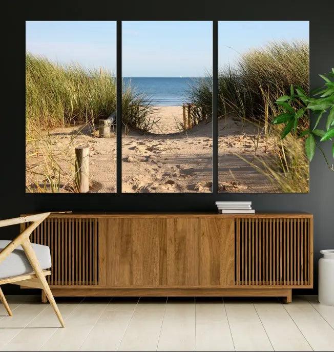 The Coastal Beach Print, showcasing a pathway to beach dunes with grass, is elegantly displayed on a gallery-wrapped museum-quality canvas. This ocean wall art canvas print features a UV-protective coating for enduring beauty.