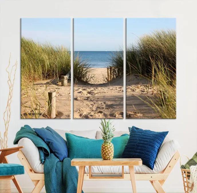 The Coastal Beach Print, showcasing a pathway to beach dunes with grass, is elegantly displayed on a gallery-wrapped museum-quality canvas. This ocean wall art canvas print features a UV-protective coating for enduring beauty.