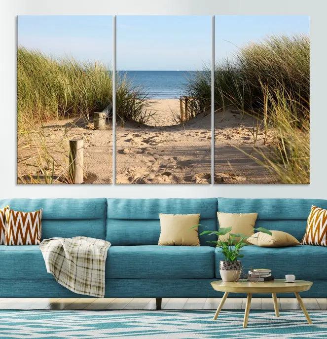 The Coastal Beach Print, showcasing a pathway to beach dunes with grass, is elegantly displayed on a gallery-wrapped museum-quality canvas. This ocean wall art canvas print features a UV-protective coating for enduring beauty.