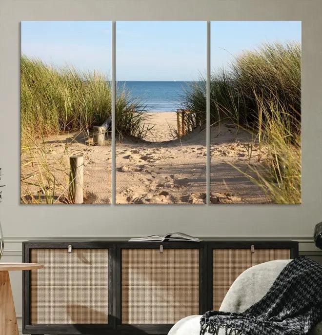 The Coastal Beach Print, showcasing a pathway to beach dunes with grass, is elegantly displayed on a gallery-wrapped museum-quality canvas. This ocean wall art canvas print features a UV-protective coating for enduring beauty.