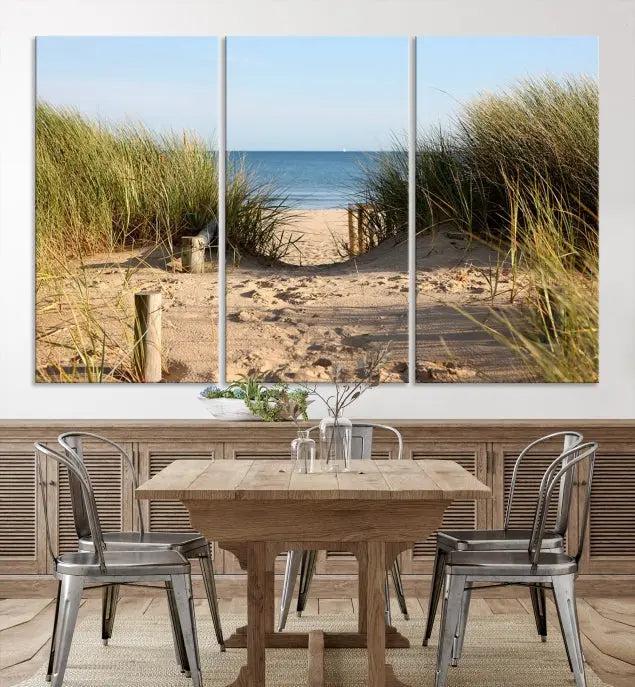 The Coastal Beach Print, showcasing a pathway to beach dunes with grass, is elegantly displayed on a gallery-wrapped museum-quality canvas. This ocean wall art canvas print features a UV-protective coating for enduring beauty.