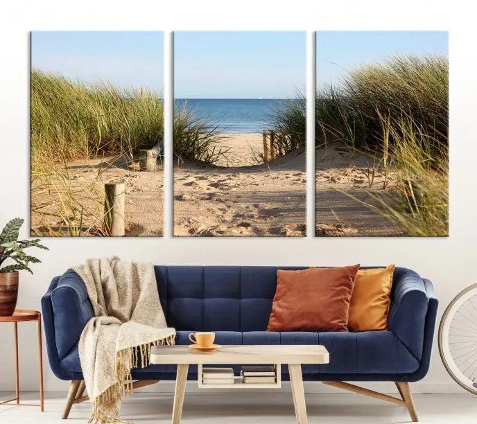 The Coastal Beach Print, showcasing a pathway to beach dunes with grass, is elegantly displayed on a gallery-wrapped museum-quality canvas. This ocean wall art canvas print features a UV-protective coating for enduring beauty.