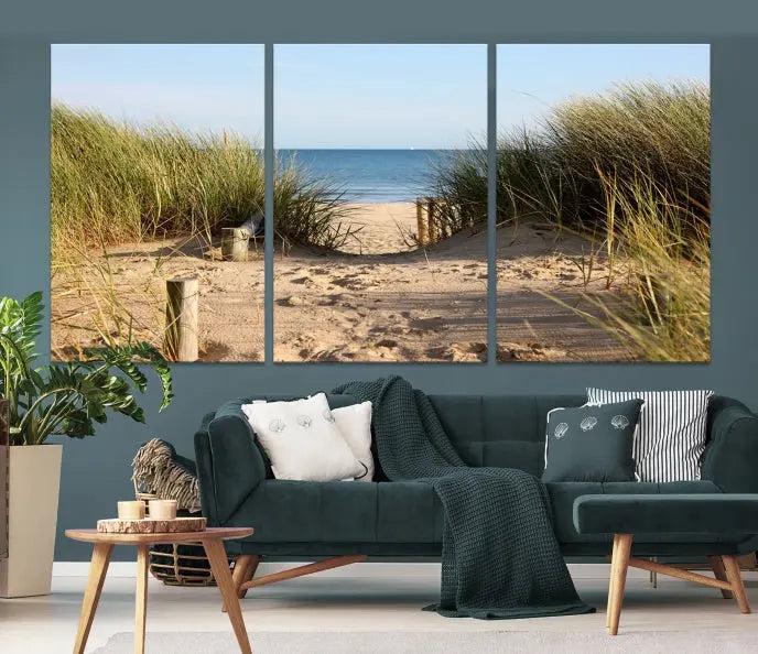 The Coastal Beach Print, showcasing a pathway to beach dunes with grass, is elegantly displayed on a gallery-wrapped museum-quality canvas. This ocean wall art canvas print features a UV-protective coating for enduring beauty.