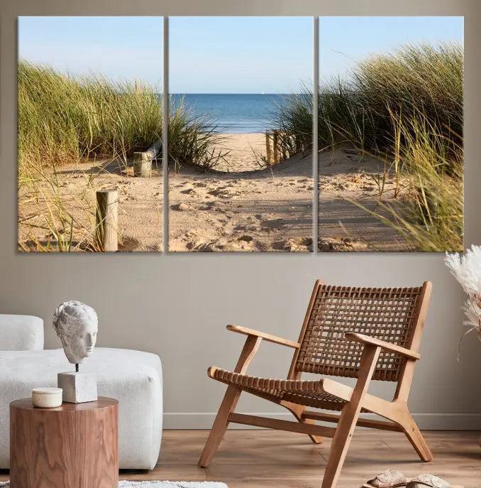 The Coastal Beach Print, showcasing a pathway to beach dunes with grass, is elegantly displayed on a gallery-wrapped museum-quality canvas. This ocean wall art canvas print features a UV-protective coating for enduring beauty.