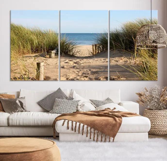 The Coastal Beach Print, showcasing a pathway to beach dunes with grass, is elegantly displayed on a gallery-wrapped museum-quality canvas. This ocean wall art canvas print features a UV-protective coating for enduring beauty.