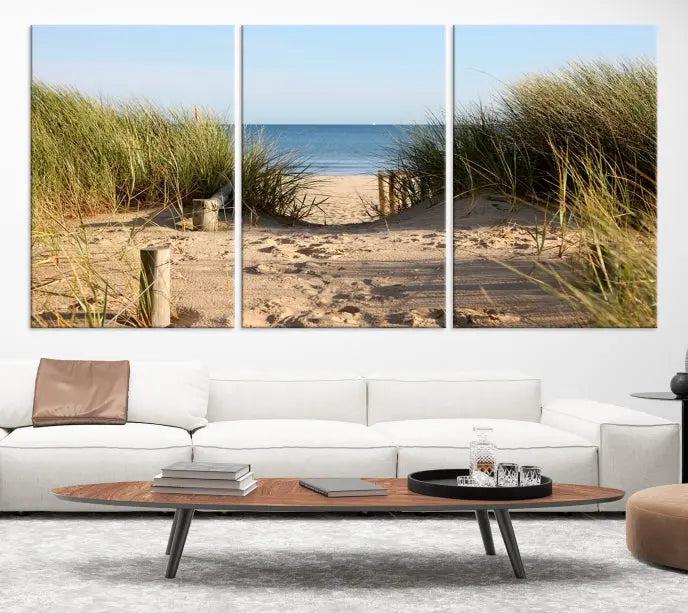 The Coastal Beach Print, showcasing a pathway to beach dunes with grass, is elegantly displayed on a gallery-wrapped museum-quality canvas. This ocean wall art canvas print features a UV-protective coating for enduring beauty.