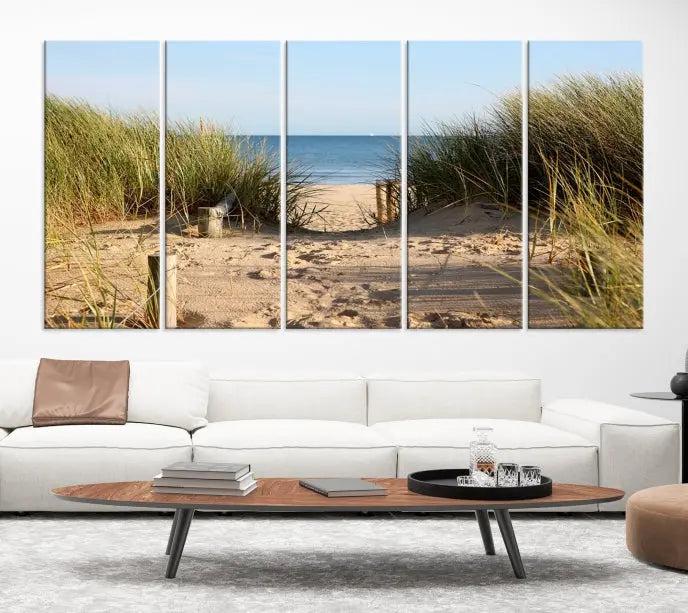 The Coastal Beach Print, showcasing a pathway to beach dunes with grass, is elegantly displayed on a gallery-wrapped museum-quality canvas. This ocean wall art canvas print features a UV-protective coating for enduring beauty.