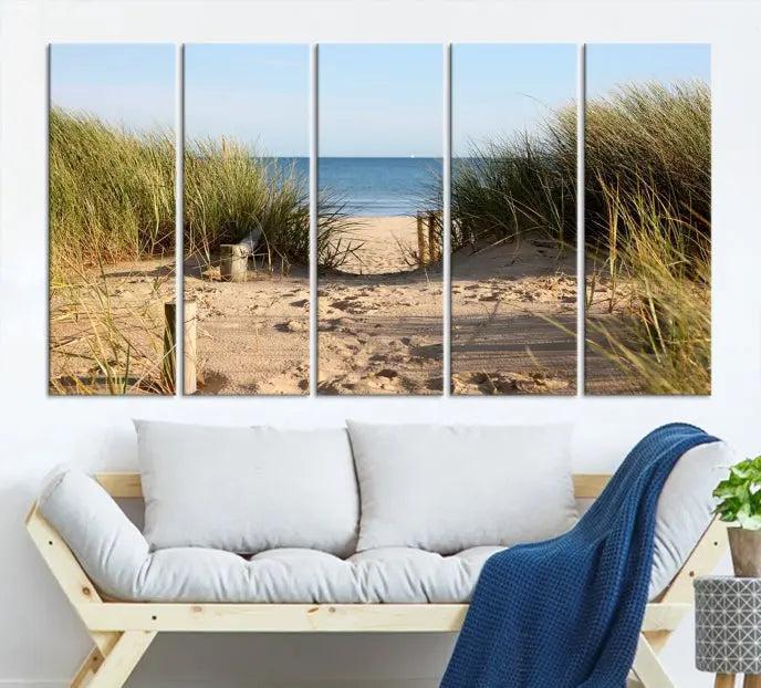 The Coastal Beach Print, showcasing a pathway to beach dunes with grass, is elegantly displayed on a gallery-wrapped museum-quality canvas. This ocean wall art canvas print features a UV-protective coating for enduring beauty.