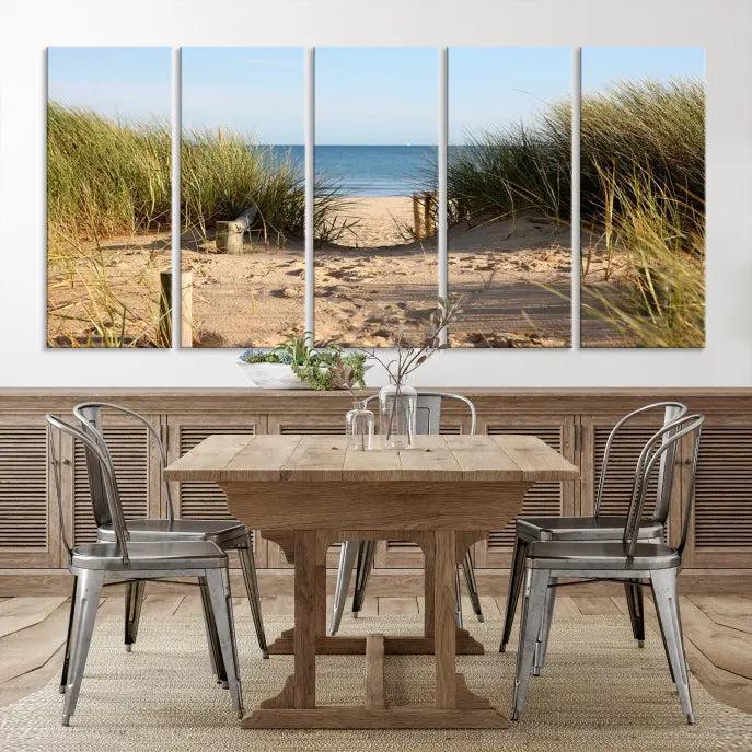 The Coastal Beach Print, showcasing a pathway to beach dunes with grass, is elegantly displayed on a gallery-wrapped museum-quality canvas. This ocean wall art canvas print features a UV-protective coating for enduring beauty.