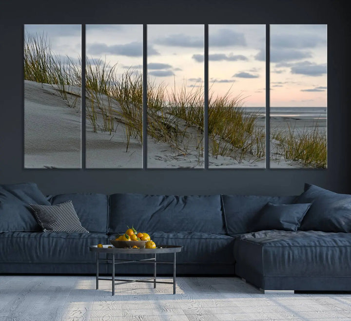 The Coastal Ocean Landscape Beach Wall Art Canvas Print is a triptych depicting sandy dunes and grass at sunset. It arrives ready to hang and is equipped with a UV-protective coating for lasting vibrancy and protection against fading sunlight.