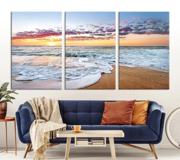 The living room features the Coastal Sunset Art Beach Canvas Wall Art Print, a large 3-panel seascape that beautifully depicts ocean waves during a beach sunset.