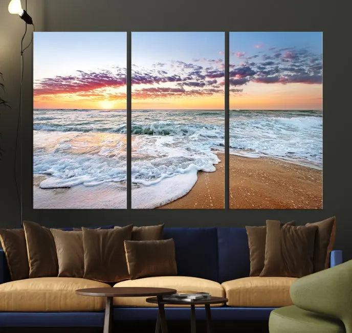 The living room features the Coastal Sunset Art Beach Canvas Wall Art Print, a large 3-panel seascape that beautifully depicts ocean waves during a beach sunset.