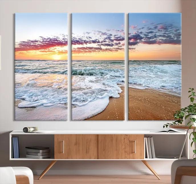 The living room features the Coastal Sunset Art Beach Canvas Wall Art Print, a large 3-panel seascape that beautifully depicts ocean waves during a beach sunset.