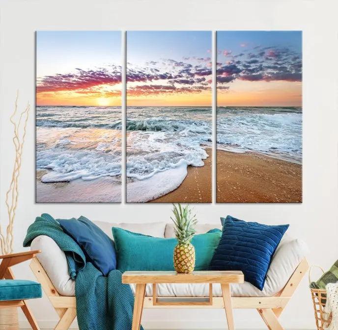 The living room features the Coastal Sunset Art Beach Canvas Wall Art Print, a large 3-panel seascape that beautifully depicts ocean waves during a beach sunset.