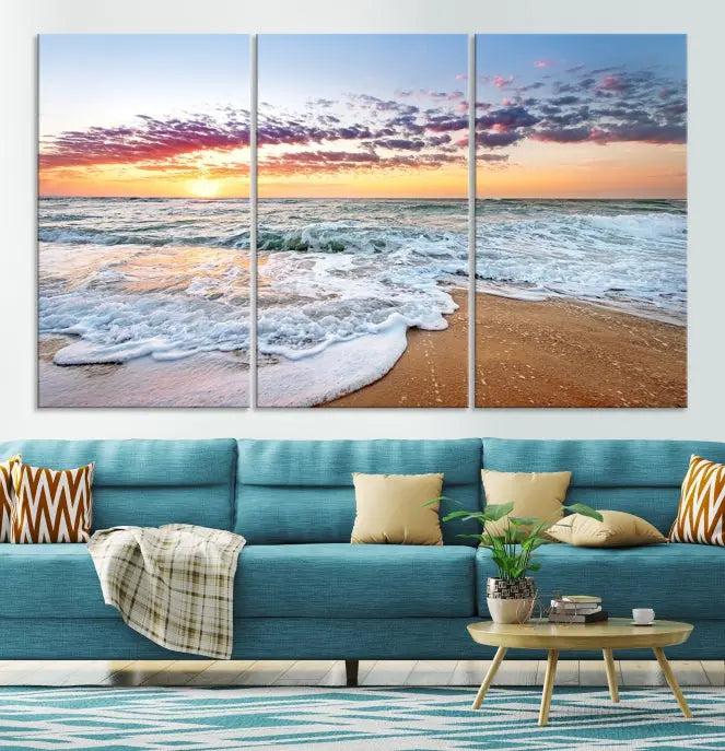 The living room features the Coastal Sunset Art Beach Canvas Wall Art Print, a large 3-panel seascape that beautifully depicts ocean waves during a beach sunset.