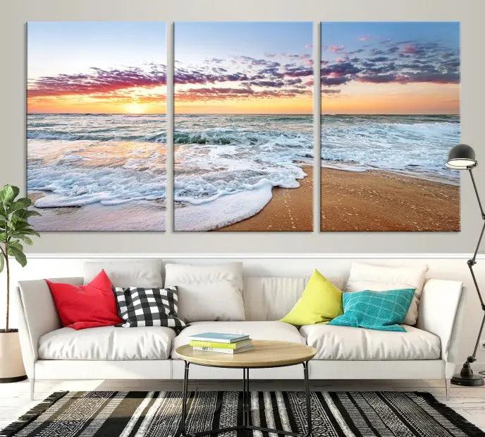 The living room features the Coastal Sunset Art Beach Canvas Wall Art Print, a large 3-panel seascape that beautifully depicts ocean waves during a beach sunset.