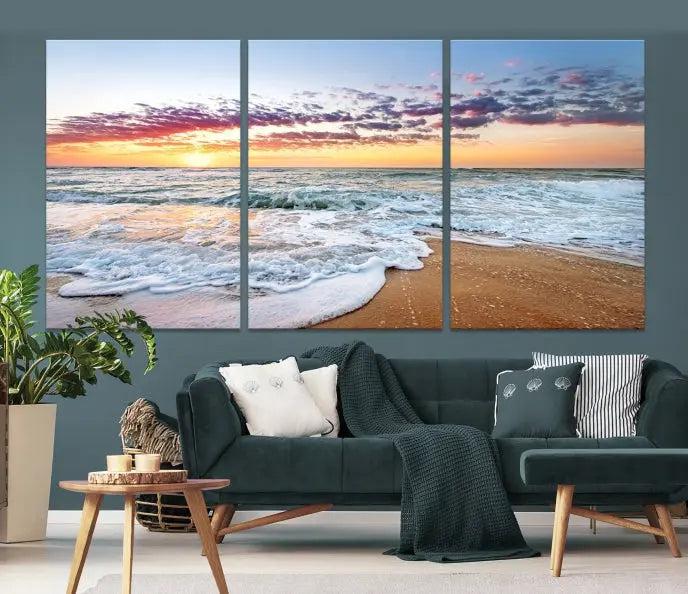 The living room features the Coastal Sunset Art Beach Canvas Wall Art Print, a large 3-panel seascape that beautifully depicts ocean waves during a beach sunset.