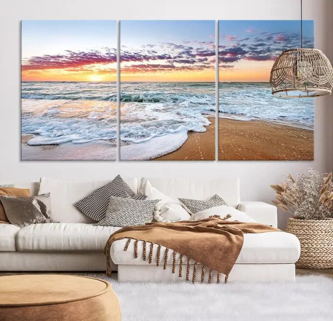 The living room features the Coastal Sunset Art Beach Canvas Wall Art Print, a large 3-panel seascape that beautifully depicts ocean waves during a beach sunset.