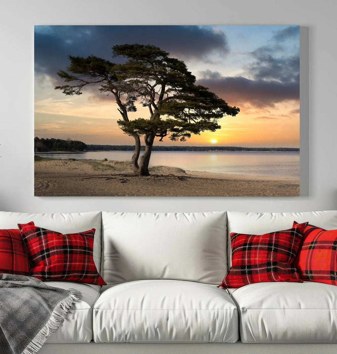 The room showcases the Coastal Sunset Wall Art Canvas Print, a triptych elegantly displayed on museum-quality polycotton canvas, depicting a serene beach sunset with a tree.