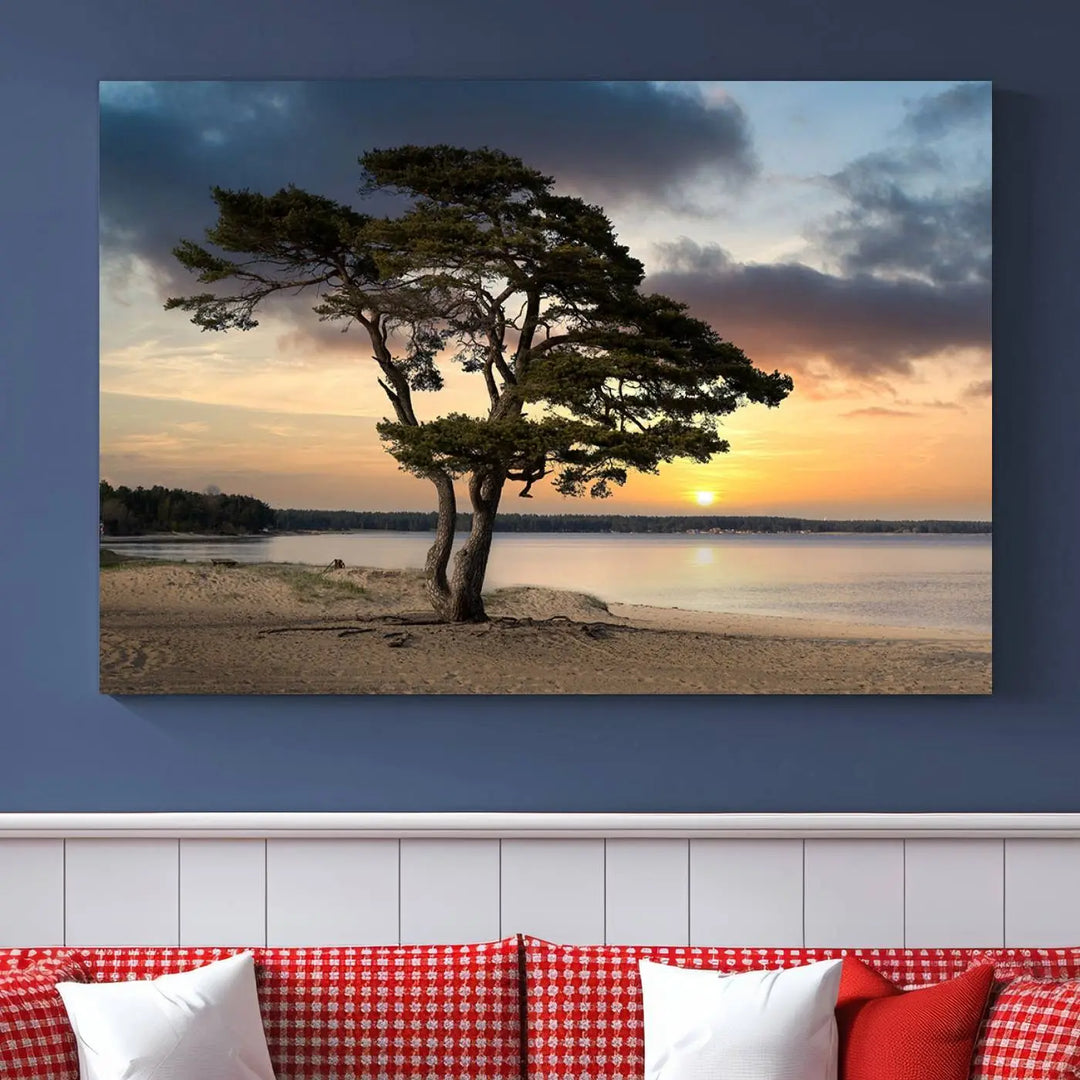 The room showcases the Coastal Sunset Wall Art Canvas Print, a triptych elegantly displayed on museum-quality polycotton canvas, depicting a serene beach sunset with a tree.