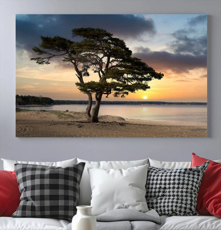 The room showcases the Coastal Sunset Wall Art Canvas Print, a triptych elegantly displayed on museum-quality polycotton canvas, depicting a serene beach sunset with a tree.