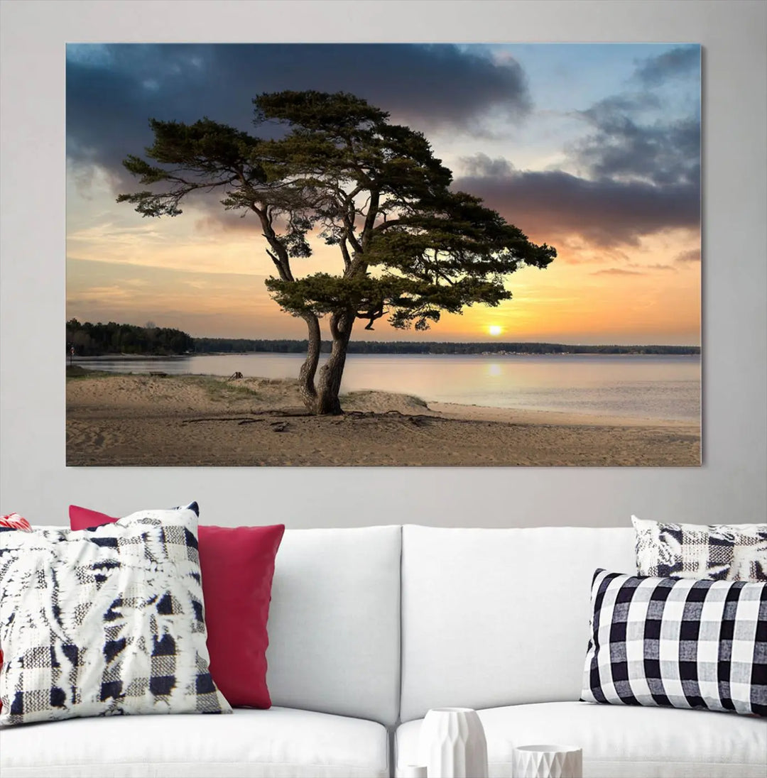 The room showcases the Coastal Sunset Wall Art Canvas Print, a triptych elegantly displayed on museum-quality polycotton canvas, depicting a serene beach sunset with a tree.