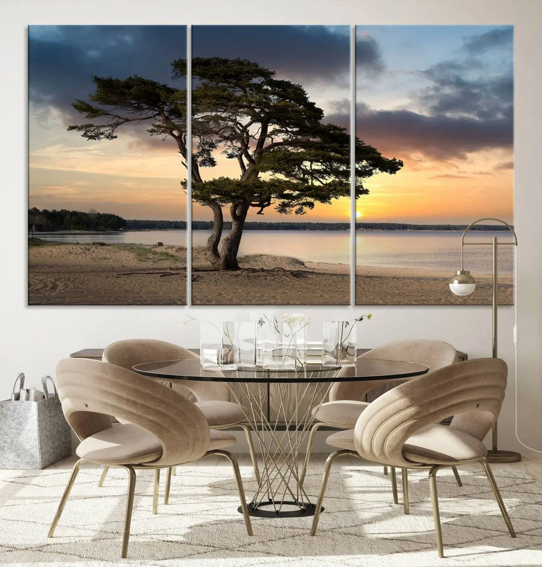 The room showcases the Coastal Sunset Wall Art Canvas Print, a triptych elegantly displayed on museum-quality polycotton canvas, depicting a serene beach sunset with a tree.