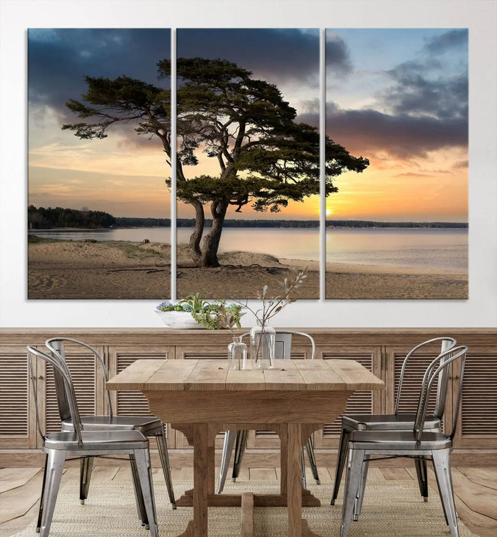 The room showcases the Coastal Sunset Wall Art Canvas Print, a triptych elegantly displayed on museum-quality polycotton canvas, depicting a serene beach sunset with a tree.