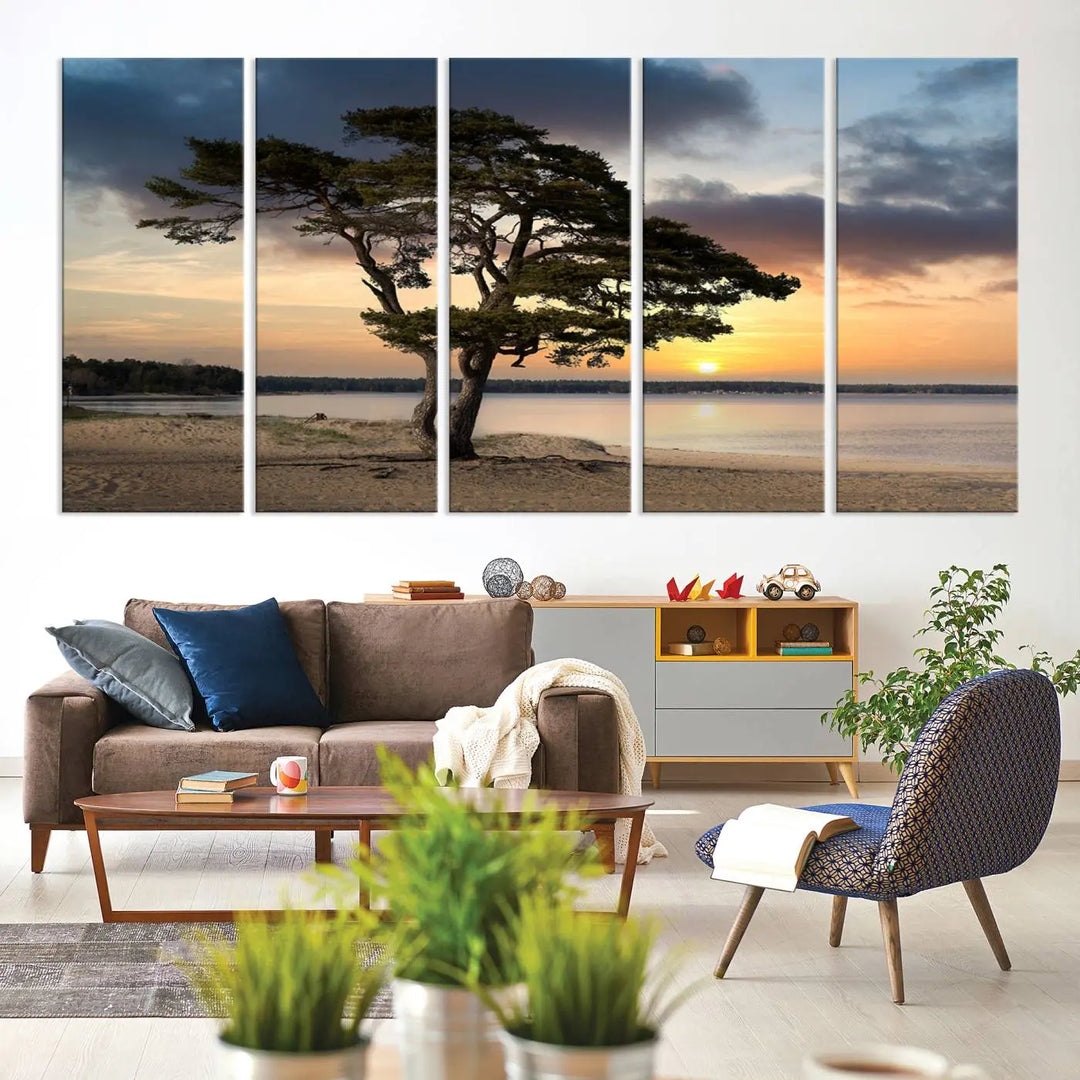 The room showcases the Coastal Sunset Wall Art Canvas Print, a triptych elegantly displayed on museum-quality polycotton canvas, depicting a serene beach sunset with a tree.