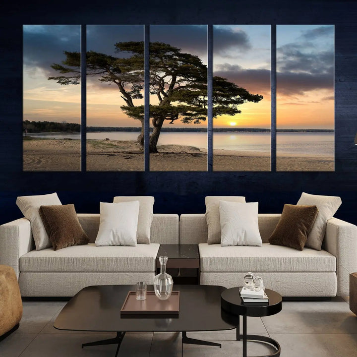 The room showcases the Coastal Sunset Wall Art Canvas Print, a triptych elegantly displayed on museum-quality polycotton canvas, depicting a serene beach sunset with a tree.