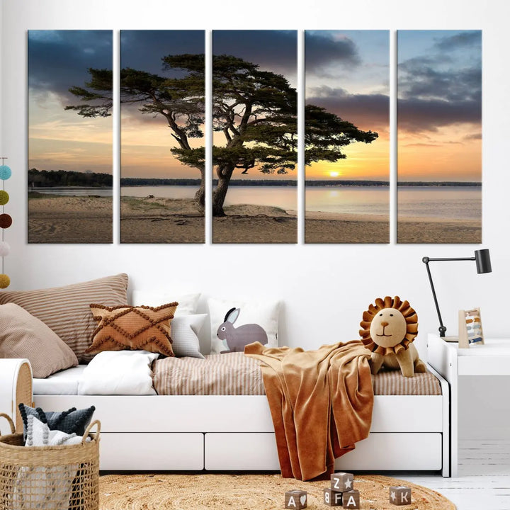 The room showcases the Coastal Sunset Wall Art Canvas Print, a triptych elegantly displayed on museum-quality polycotton canvas, depicting a serene beach sunset with a tree.