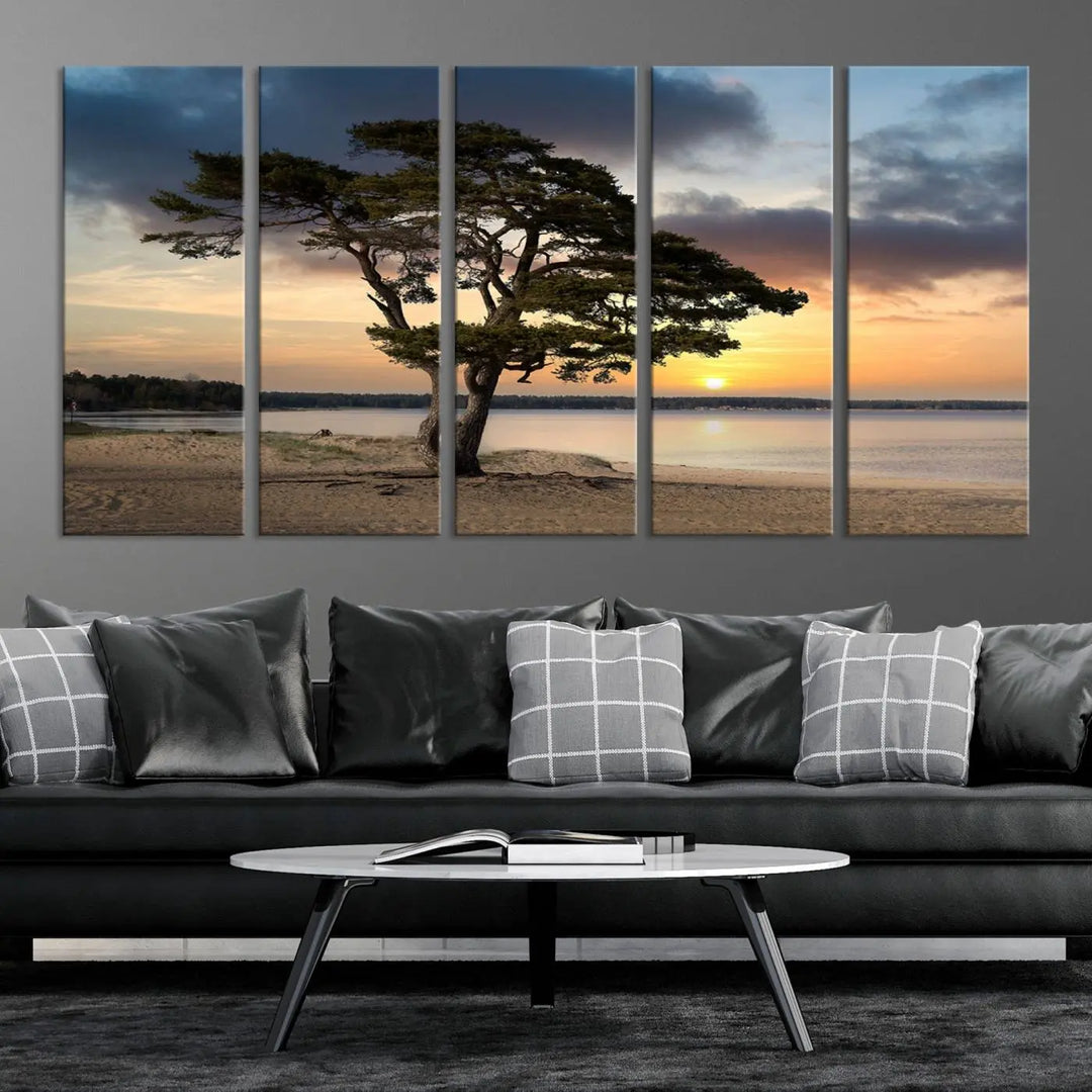 The room showcases the Coastal Sunset Wall Art Canvas Print, a triptych elegantly displayed on museum-quality polycotton canvas, depicting a serene beach sunset with a tree.