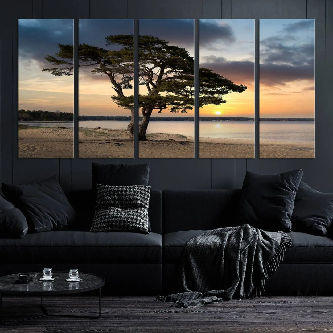 The room showcases the Coastal Sunset Wall Art Canvas Print, a triptych elegantly displayed on museum-quality polycotton canvas, depicting a serene beach sunset with a tree.