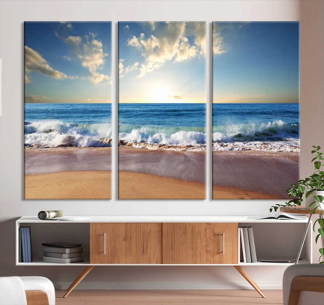 A triptych of the "Coastal Tropical Beach Sunset Canvas Wall Art Print" adorns the dark wall. Featuring a serene beach scene, its gallery-wrapped edges offer a polished look, while a UV-protective coating ensures lasting vibrancy.