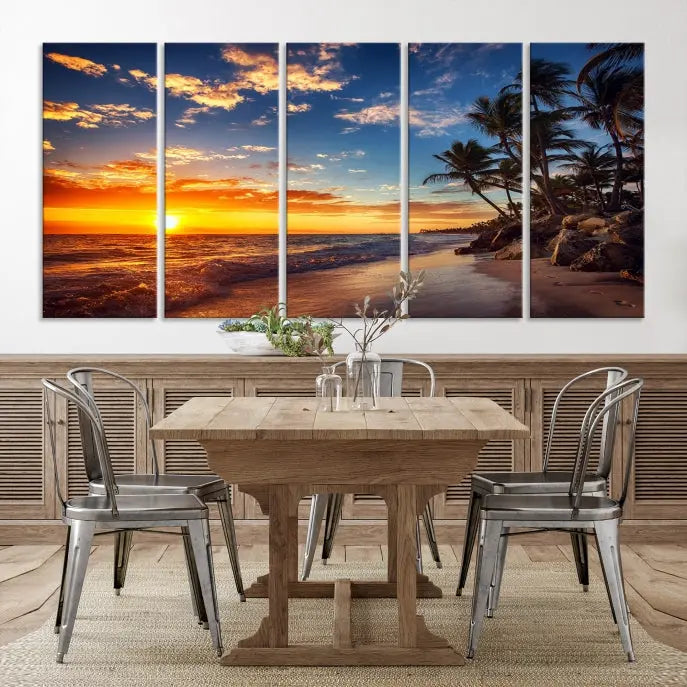 A Coastal Wall Art Beach at Sunset Canvas Print, featuring a triptych of a tropical sunset over the ocean with palm trees, graces the room.