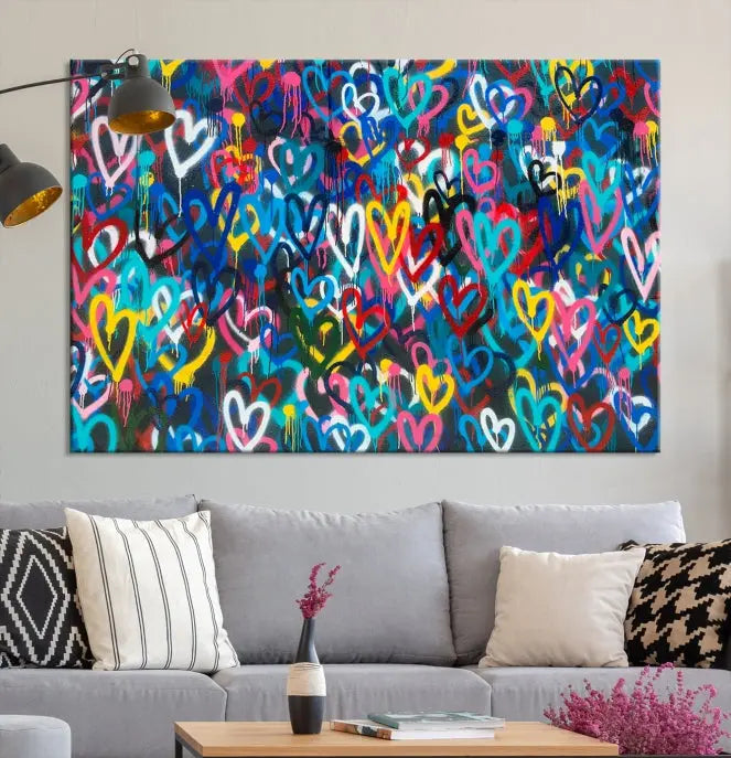 The Color Hands Wall Art Canvas Print features vibrant heart graffiti artwork on three museum-quality canvases, each expertly gallery wrapped and coated for UV protection to ensure durability.