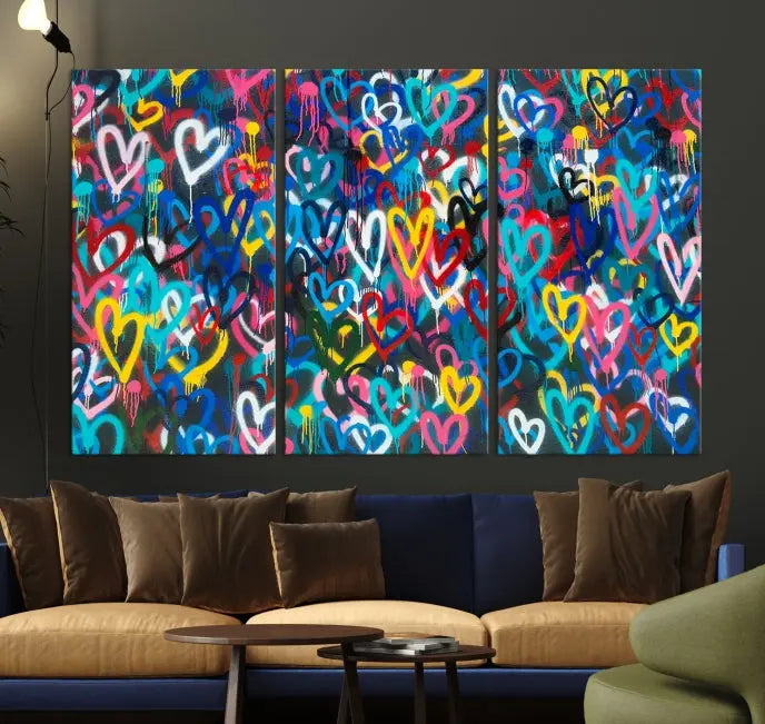 The Color Hands Wall Art Canvas Print features vibrant heart graffiti artwork on three museum-quality canvases, each expertly gallery wrapped and coated for UV protection to ensure durability.