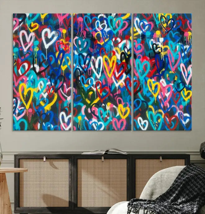 The Color Hands Wall Art Canvas Print features vibrant heart graffiti artwork on three museum-quality canvases, each expertly gallery wrapped and coated for UV protection to ensure durability.