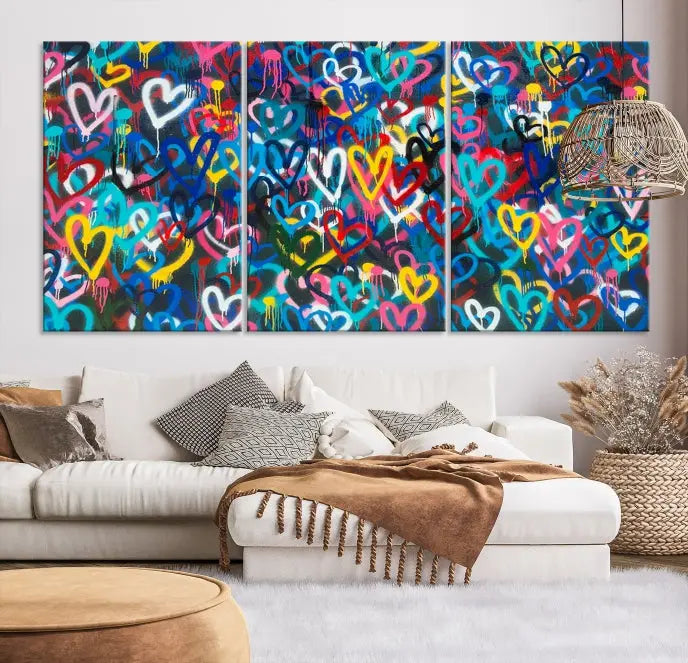 The Color Hands Wall Art Canvas Print features vibrant heart graffiti artwork on three museum-quality canvases, each expertly gallery wrapped and coated for UV protection to ensure durability.