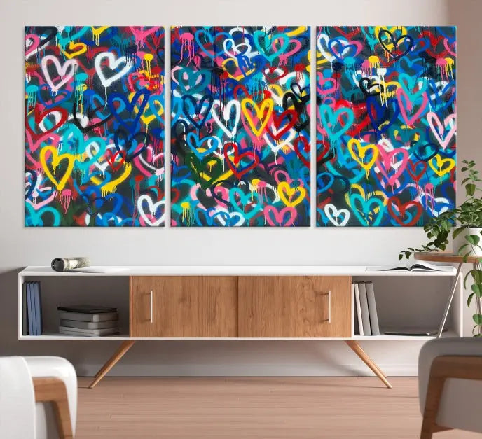 The Color Hands Wall Art Canvas Print features vibrant heart graffiti artwork on three museum-quality canvases, each expertly gallery wrapped and coated for UV protection to ensure durability.