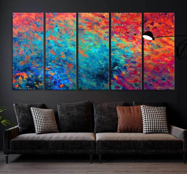 A three-part Colorful Abstract Canvas Wall Art Print, featuring vivid splashes of blue, orange, and red, is showcased on gallery-wrapped, museum-quality canvas with a UV-protective coating.