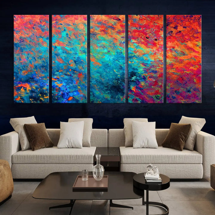 A three-part Colorful Abstract Canvas Wall Art Print, featuring vivid splashes of blue, orange, and red, is showcased on gallery-wrapped, museum-quality canvas with a UV-protective coating.