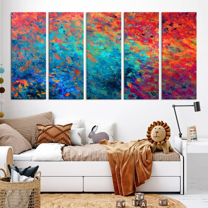 A three-part Colorful Abstract Canvas Wall Art Print, featuring vivid splashes of blue, orange, and red, is showcased on gallery-wrapped, museum-quality canvas with a UV-protective coating.