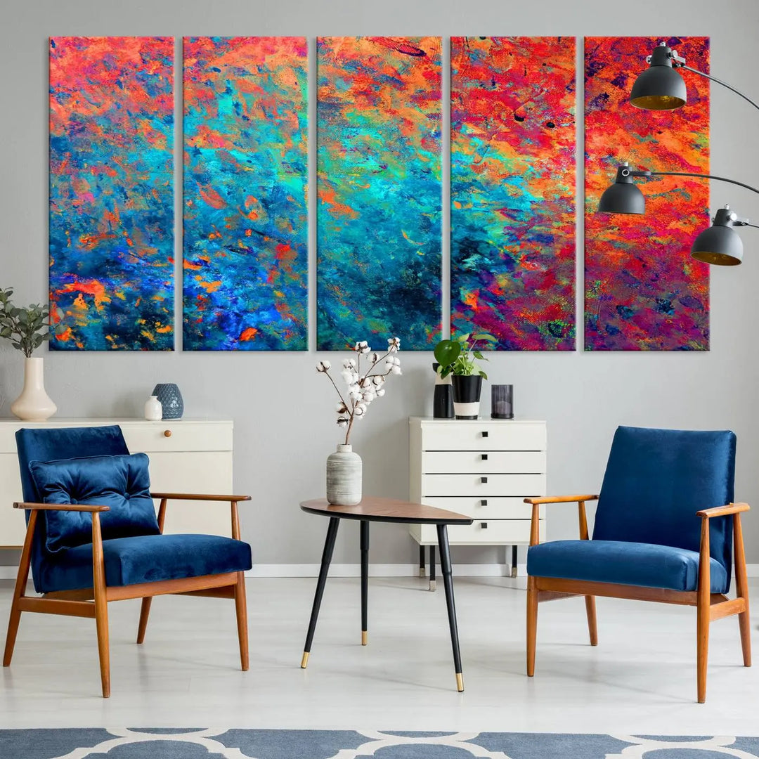 A three-part Colorful Abstract Canvas Wall Art Print, featuring vivid splashes of blue, orange, and red, is showcased on gallery-wrapped, museum-quality canvas with a UV-protective coating.