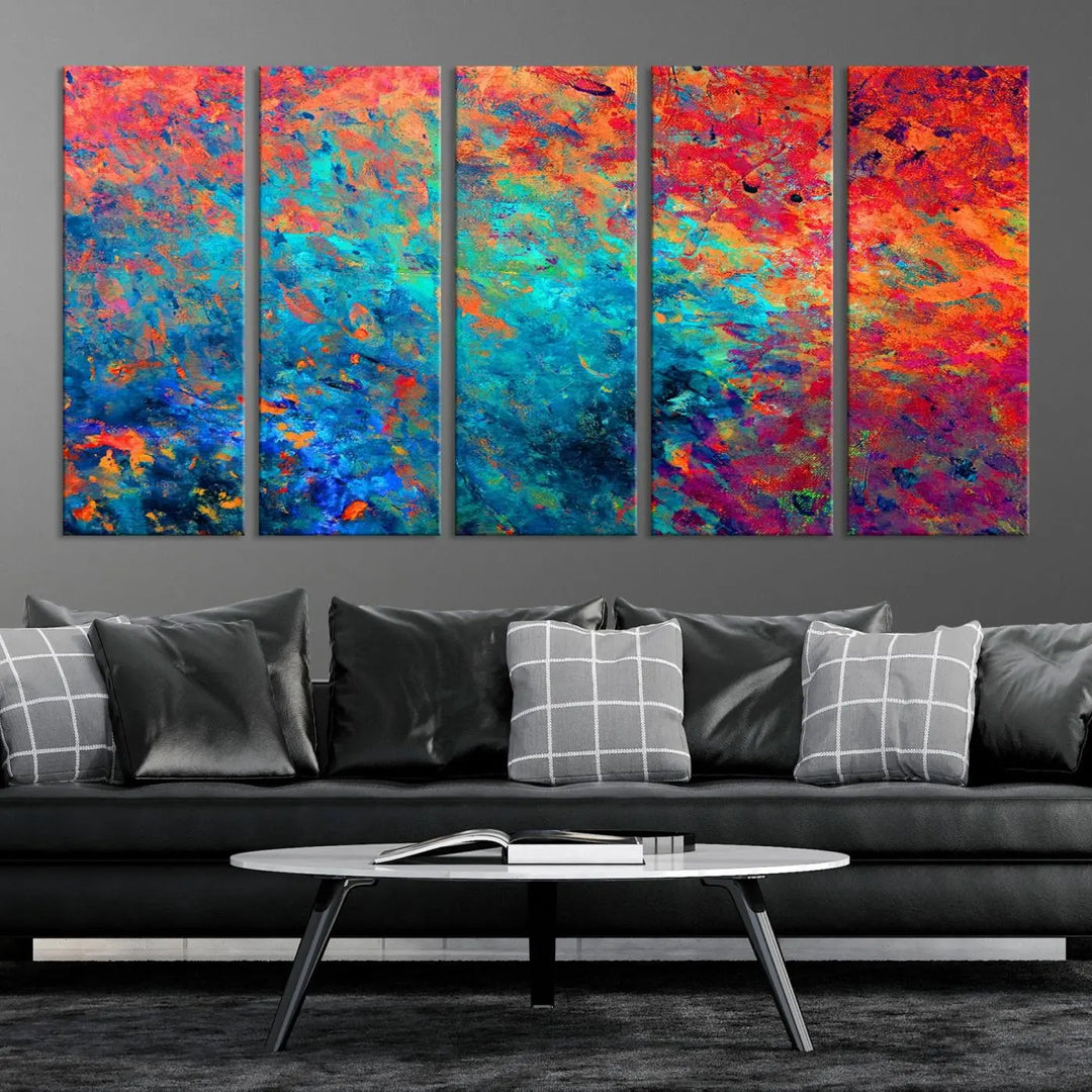 A three-part Colorful Abstract Canvas Wall Art Print, featuring vivid splashes of blue, orange, and red, is showcased on gallery-wrapped, museum-quality canvas with a UV-protective coating.